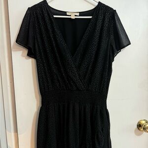 Gold dotted black dress, with ruffles, v-neck and elastic waistband.